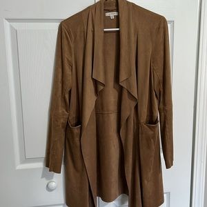 Feels like a smooth velvet on the outside. Pockets. Size S. Cooper in color.